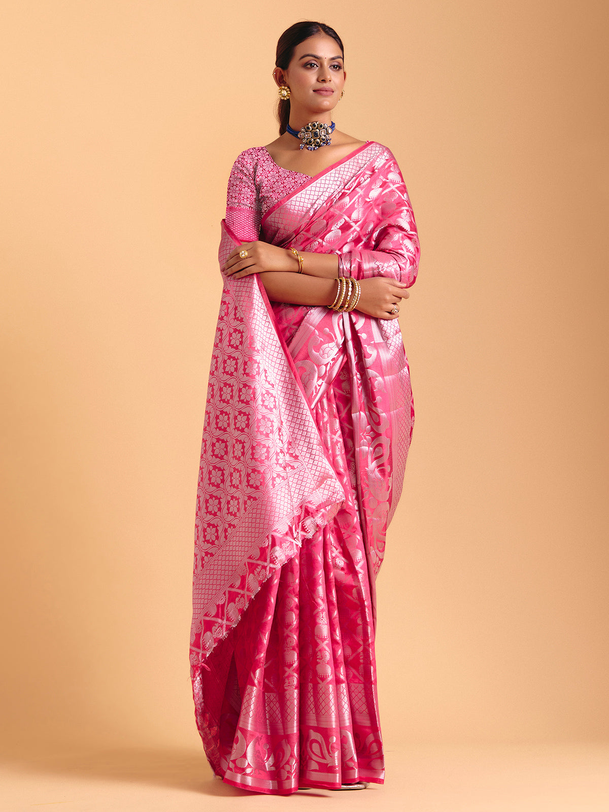 Pink silk saree enhanced with elegant zari detailing