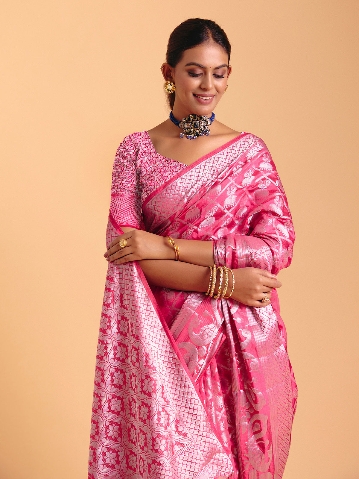 Pink silk saree enhanced with elegant zari detailing