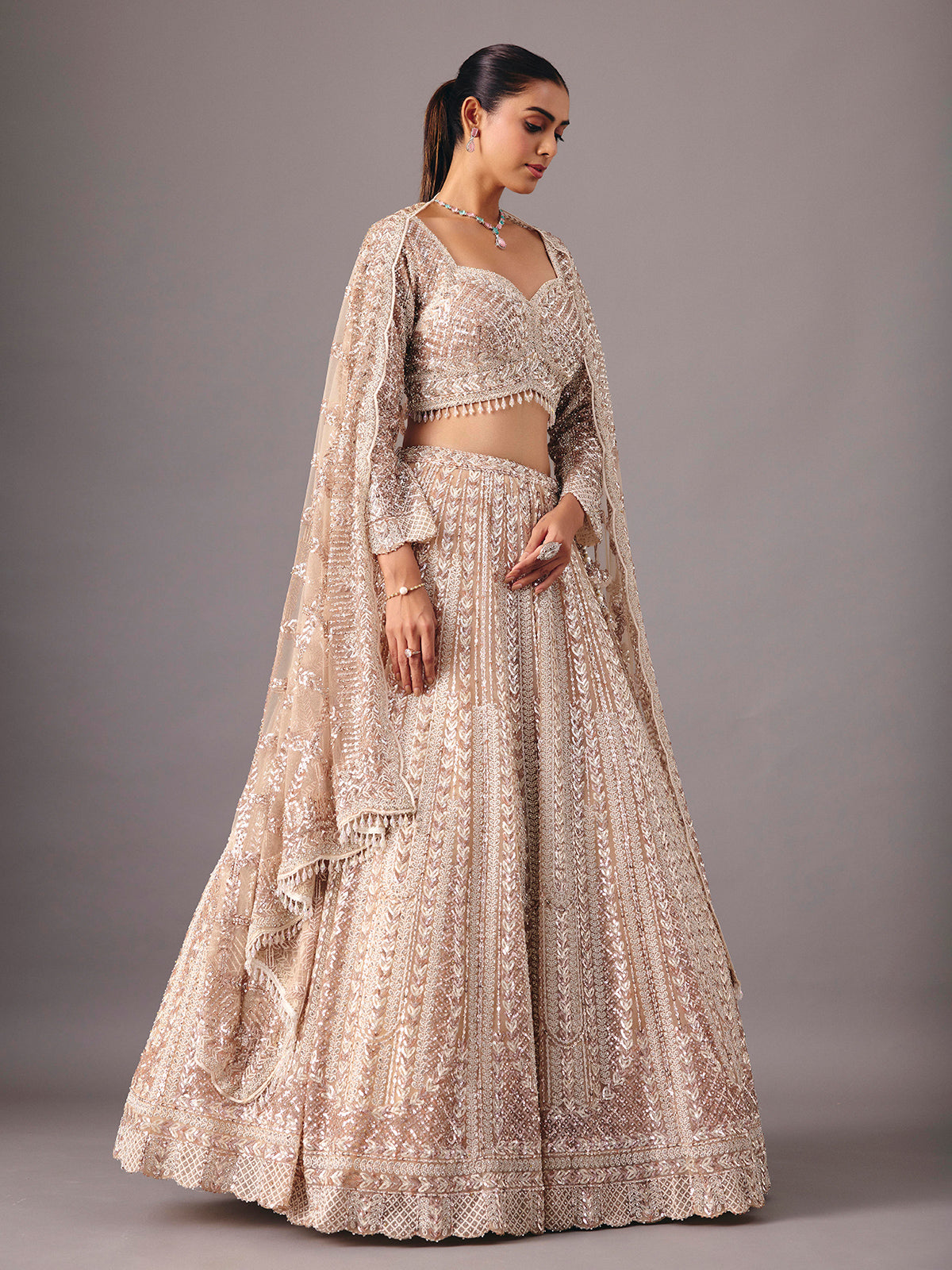 Beige net lehenga choli with pearl and sequin detailing