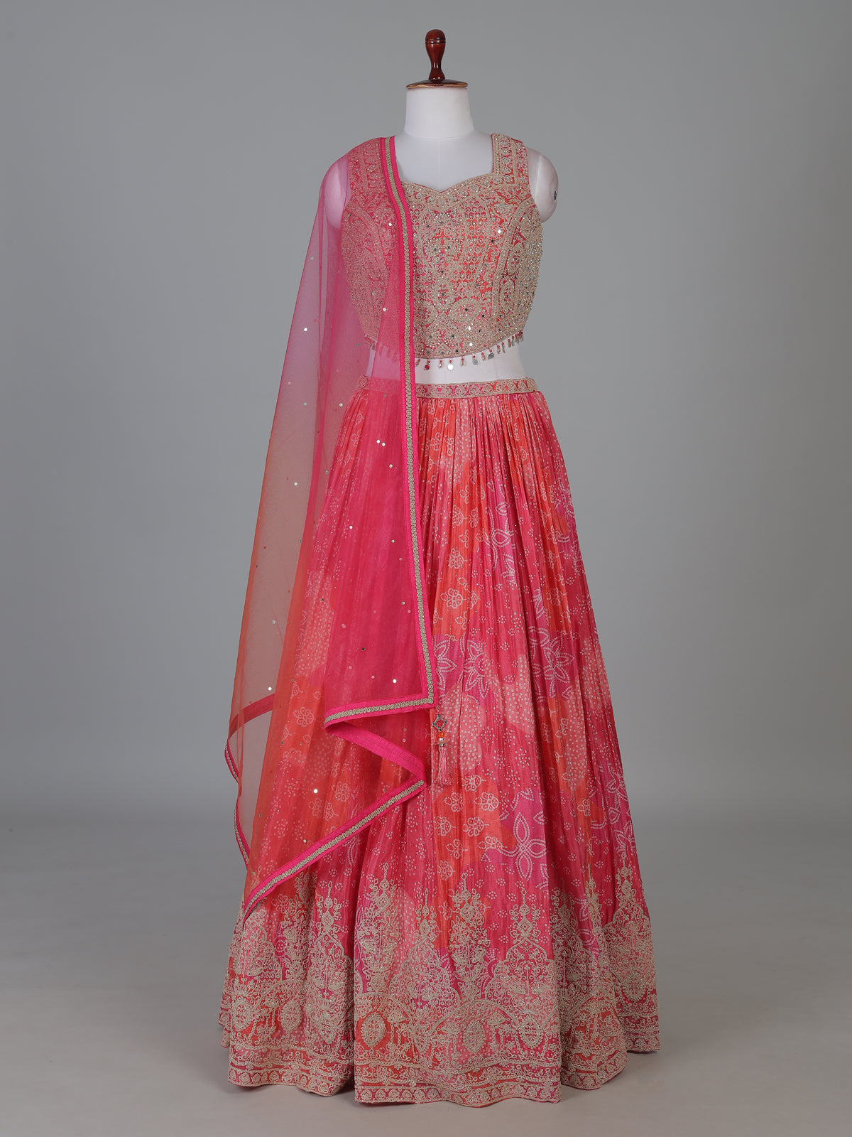 Pink silk bandhej lehenga choli with mirror and tassel work
