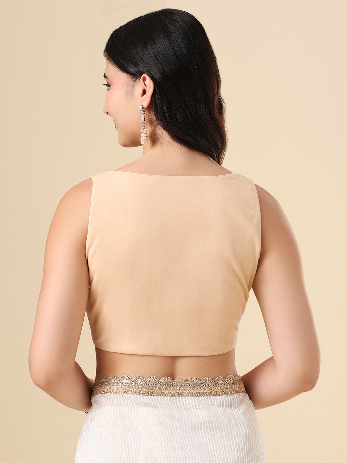 Beige cotton solid blouse with front open sleeveless design