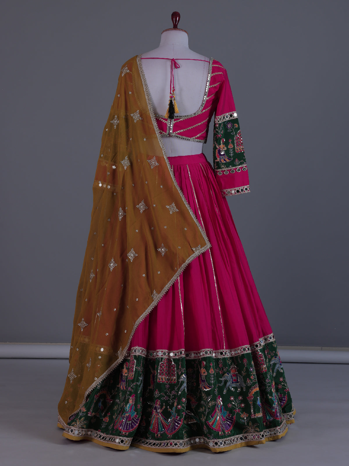 Rani pink mirror adorned festive lehenga grandeur