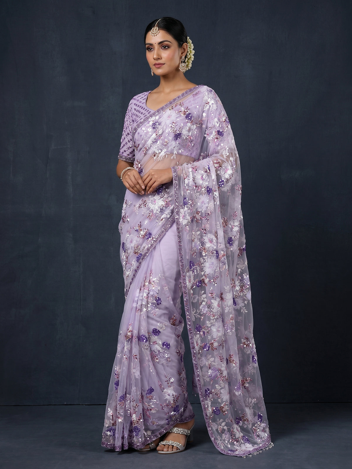 Purple reception wear net saree with heavy detailing