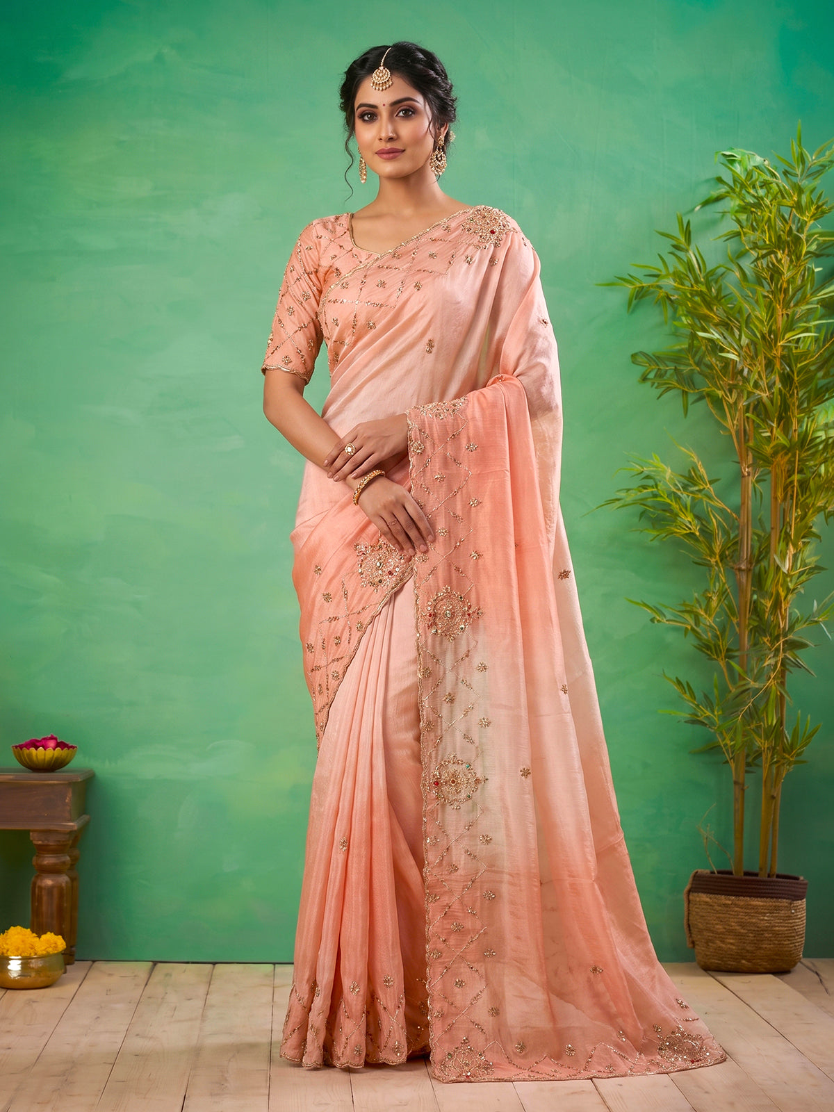 Graceful peach shaded dola shimmer saree for festive occasions
