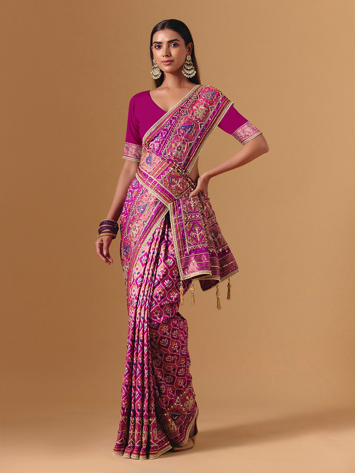 Rani pink art silk saree with graceful patola motif detailing