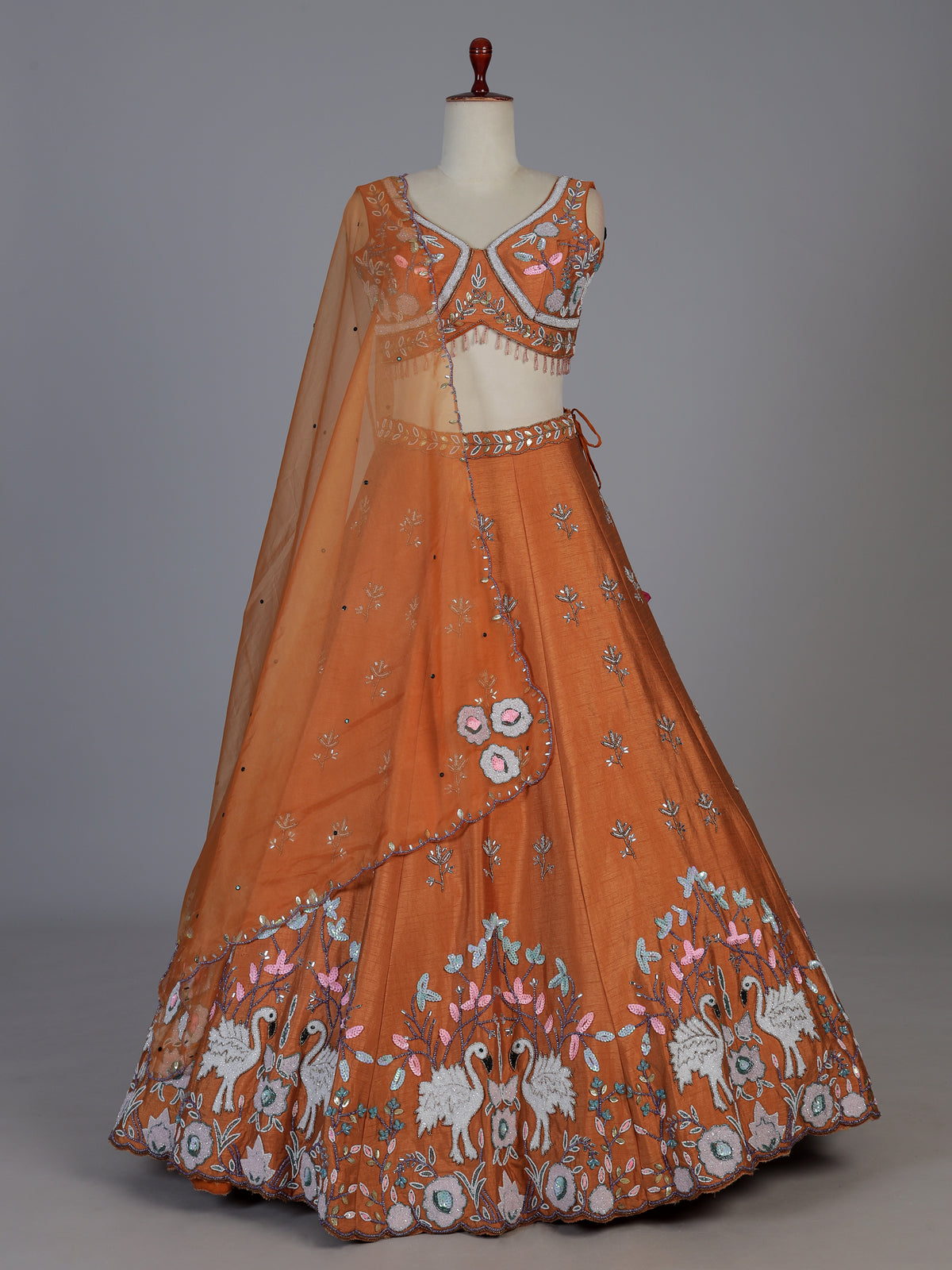 Rust orange raw silk swan motif lehenga choli with dupatta