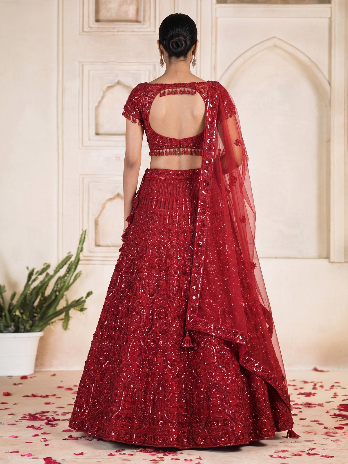 Maroon net designer lehenga choli with stone work tassel detailing