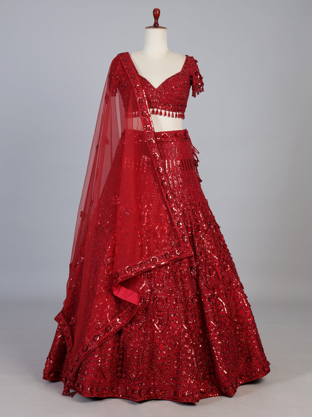 Maroon net designer lehenga choli with stone work tassel detailing