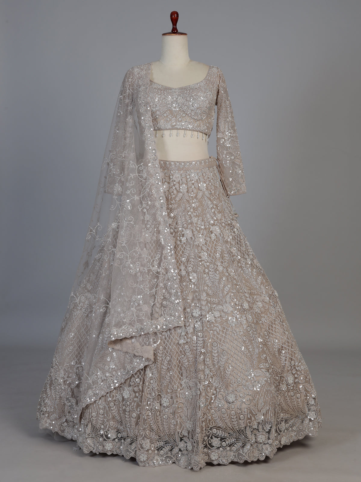 Beige net sequins embellished party lehenga choli