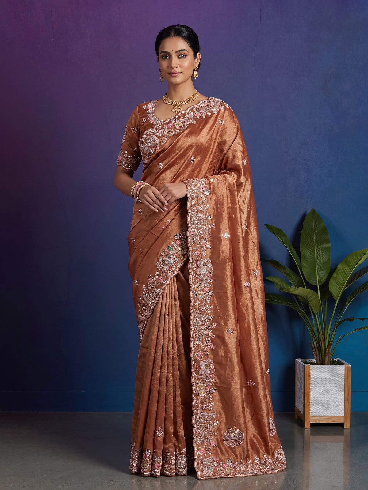 Pastel orange tissue silk saree with elephant border festive elegance