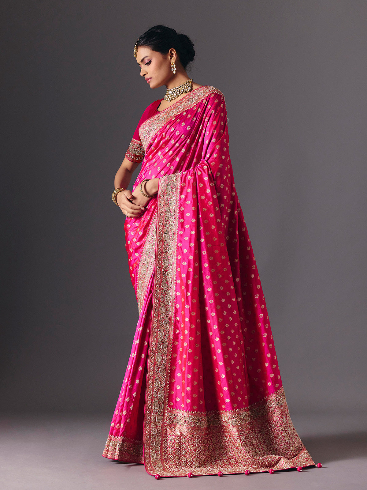 Rani pink banarasi silk saree with butti work and tassels