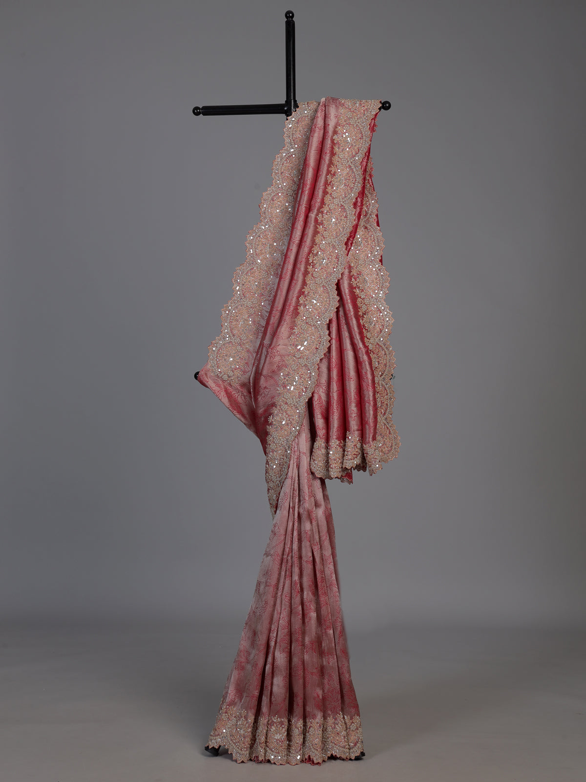 Pastel rani pink tissue silk saree with luxurious zari detailing