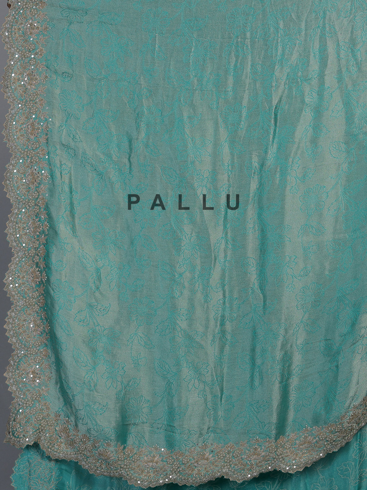 Pastel rama green tissue silk saree with elegant embellishments