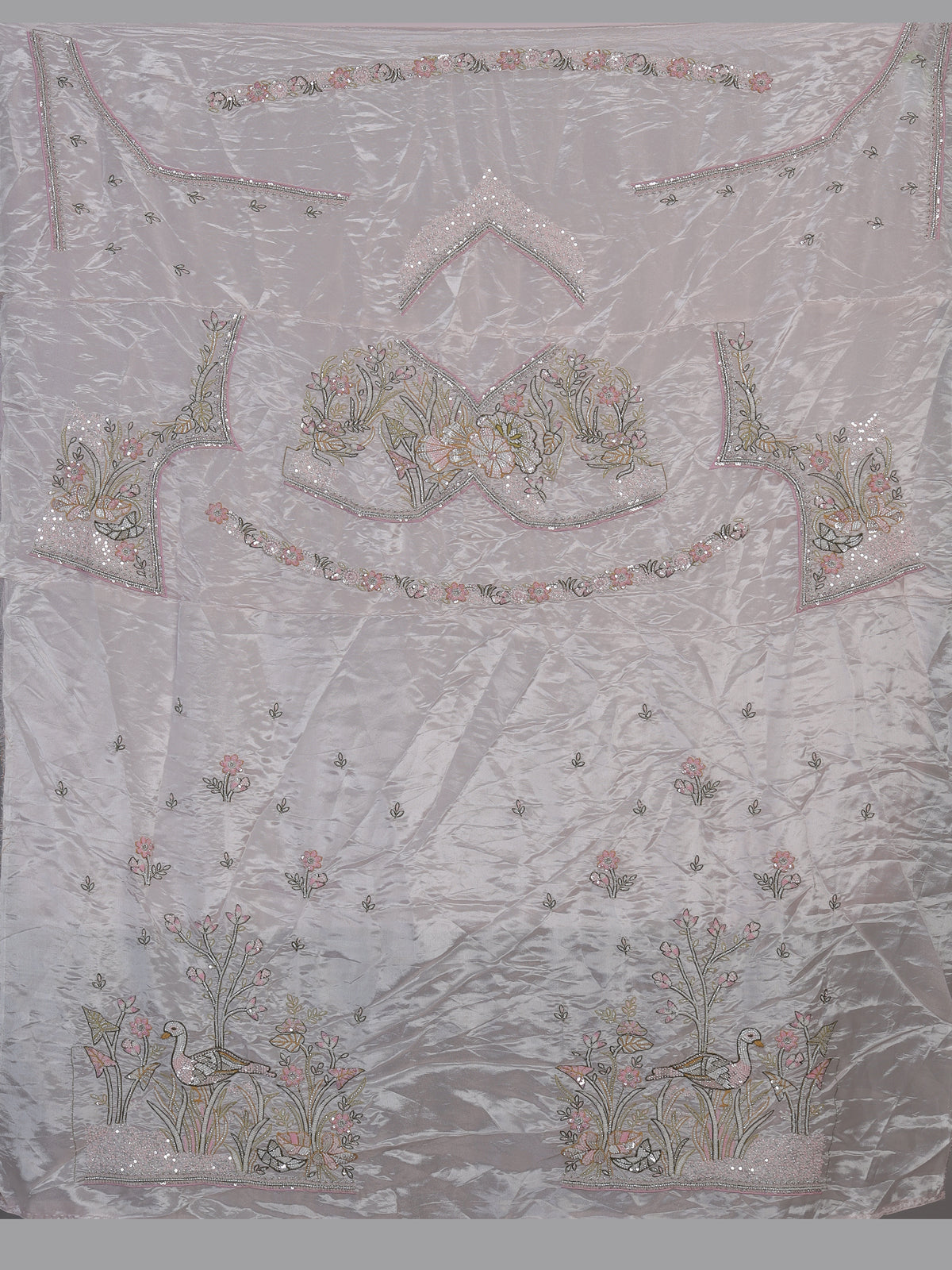 Pink tissue silk lehenga choli adorned with floral bird artistry