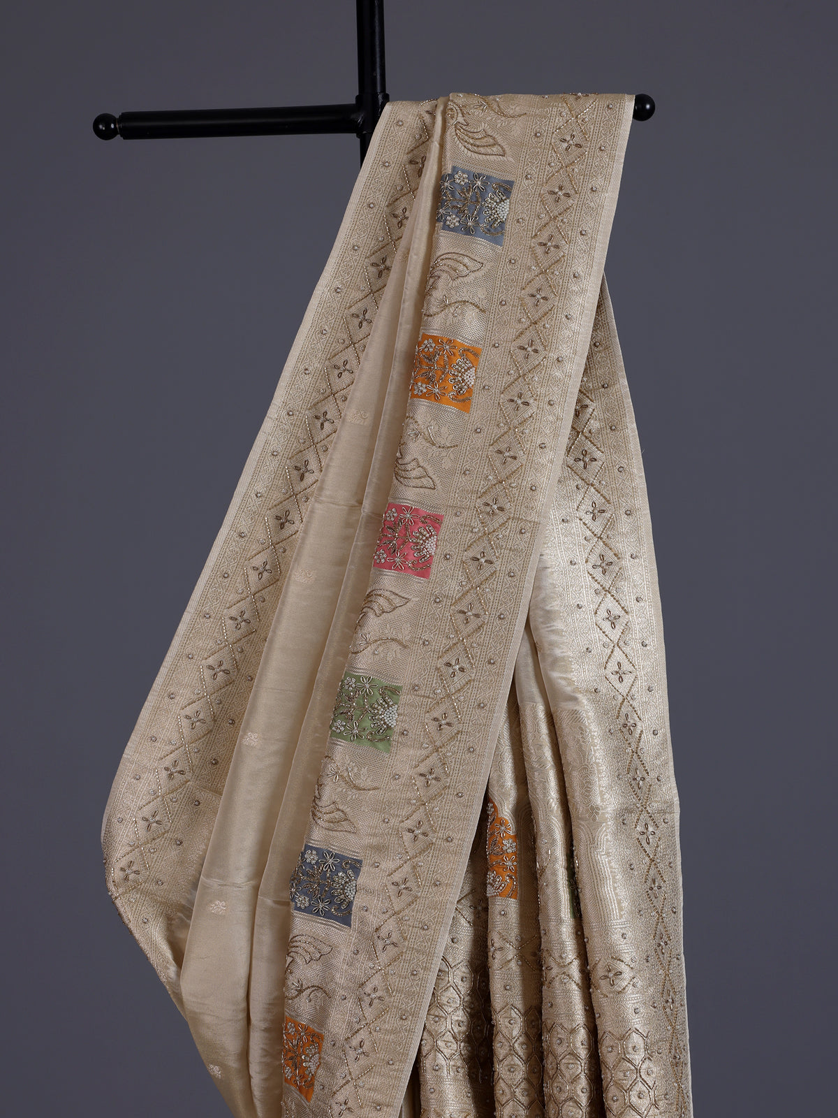 Pastel beige silk saree with delicate traditional embellishments