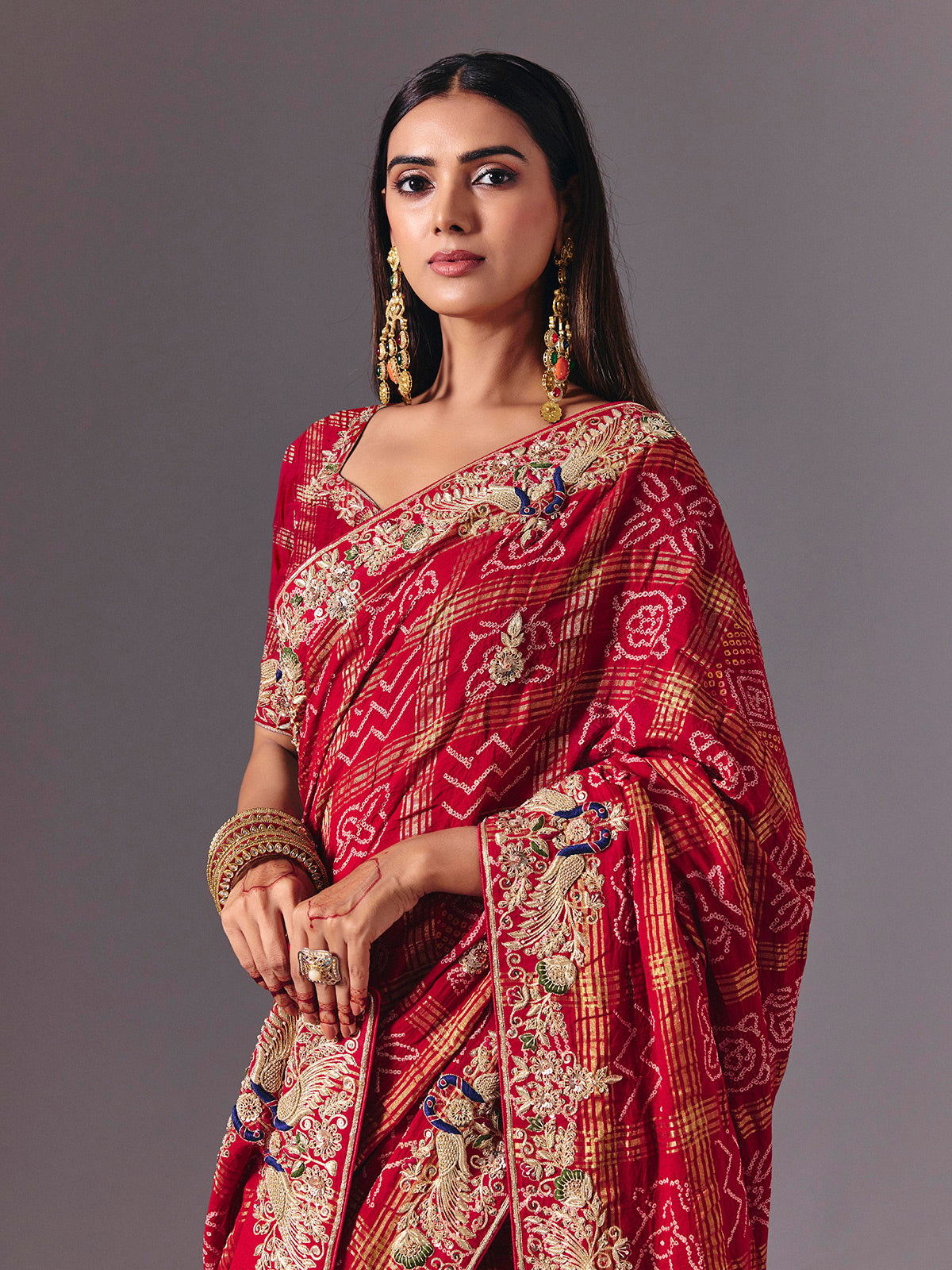 Maroon gharchola silk saree with peacock motif embellishments