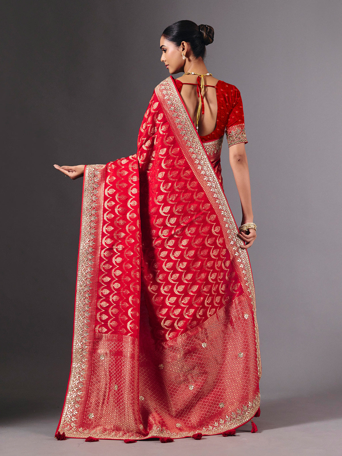 Red modal silk saree with delicate zari tassel detailing