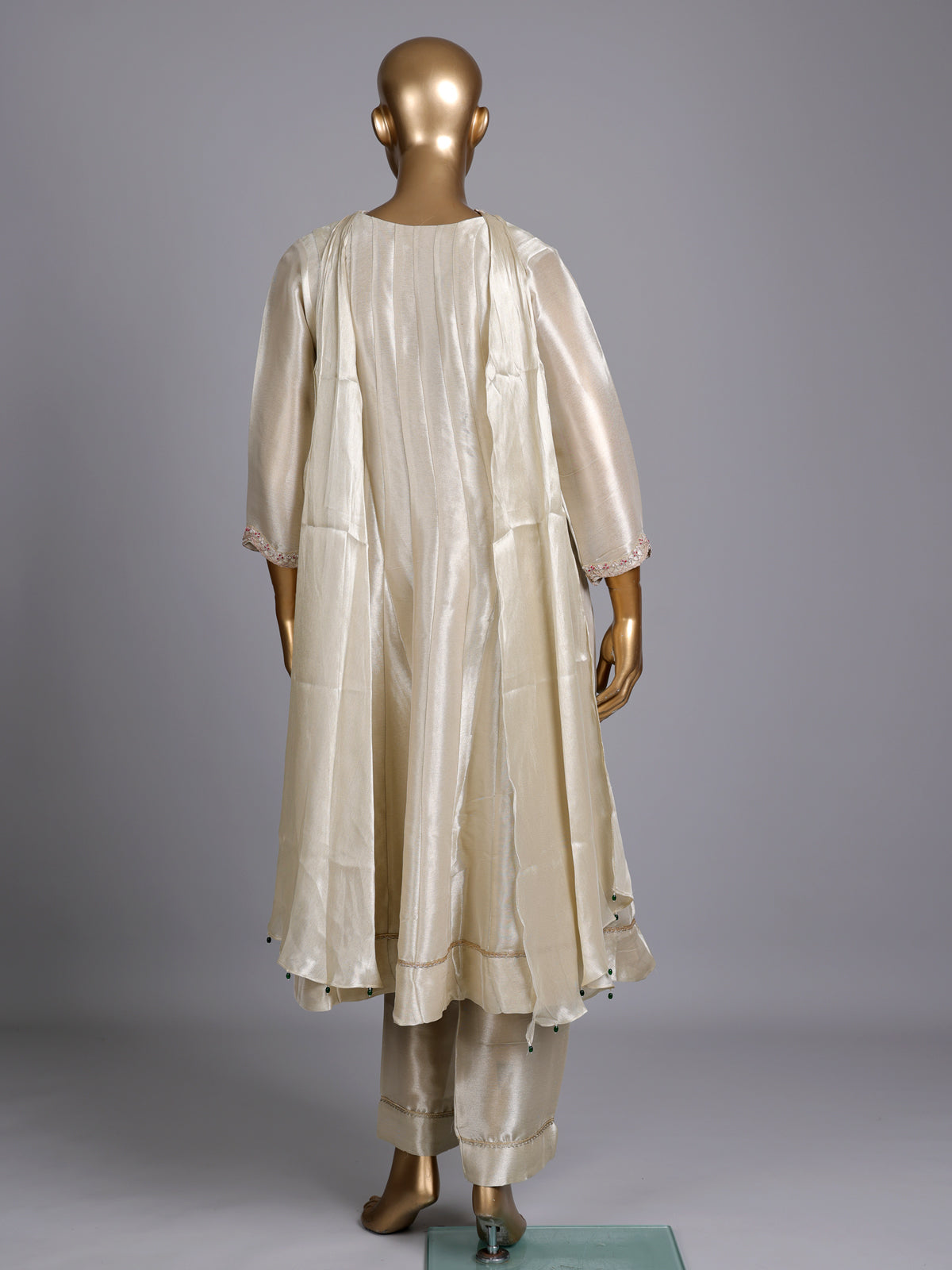 Cream silk anarkali suit with dupatta and ornate embellishments