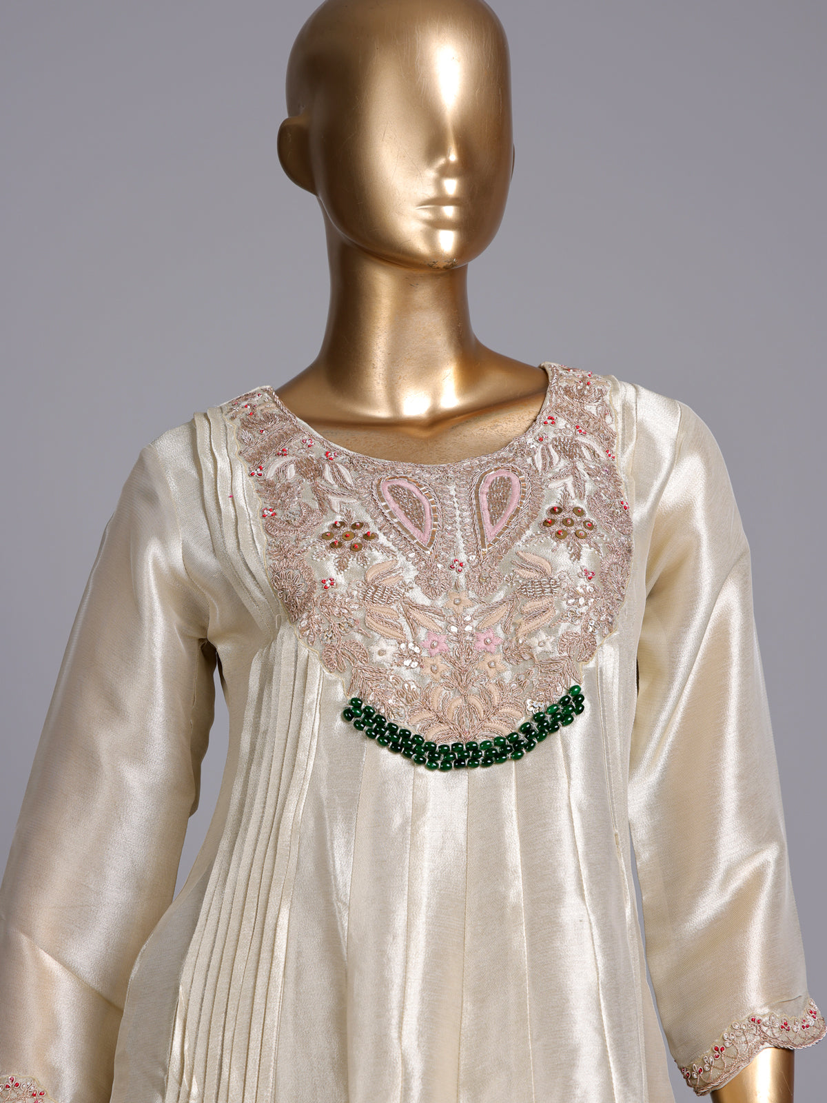 Cream silk anarkali suit with dupatta and ornate embellishments