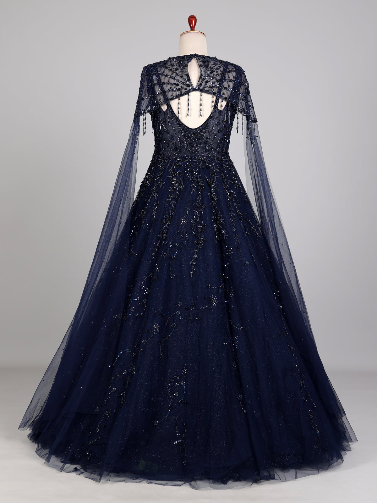 Midnight navy ball gown with embellished cape and flared skirt
