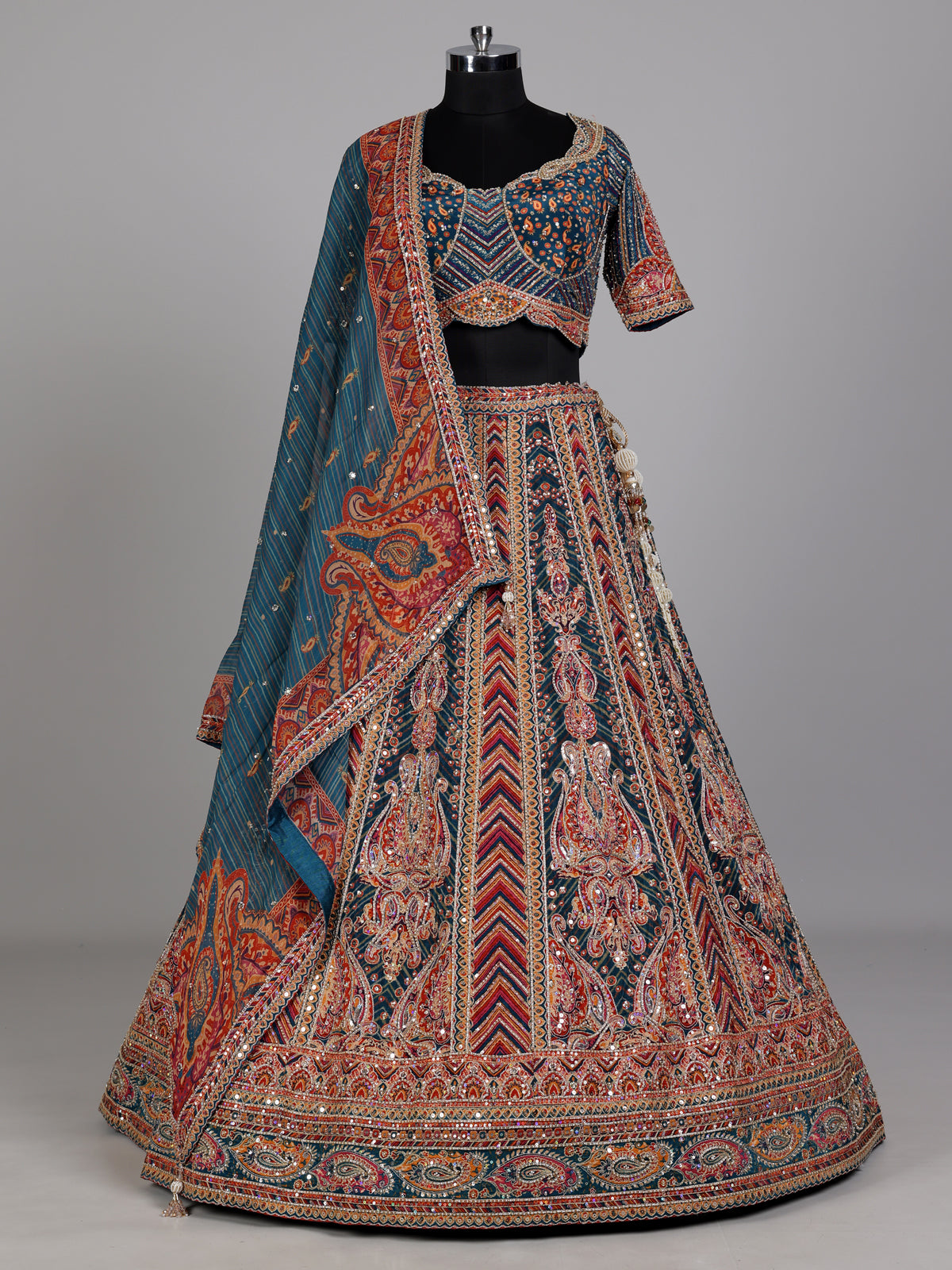 Teal blue lehenga choli with rust paisley detailing