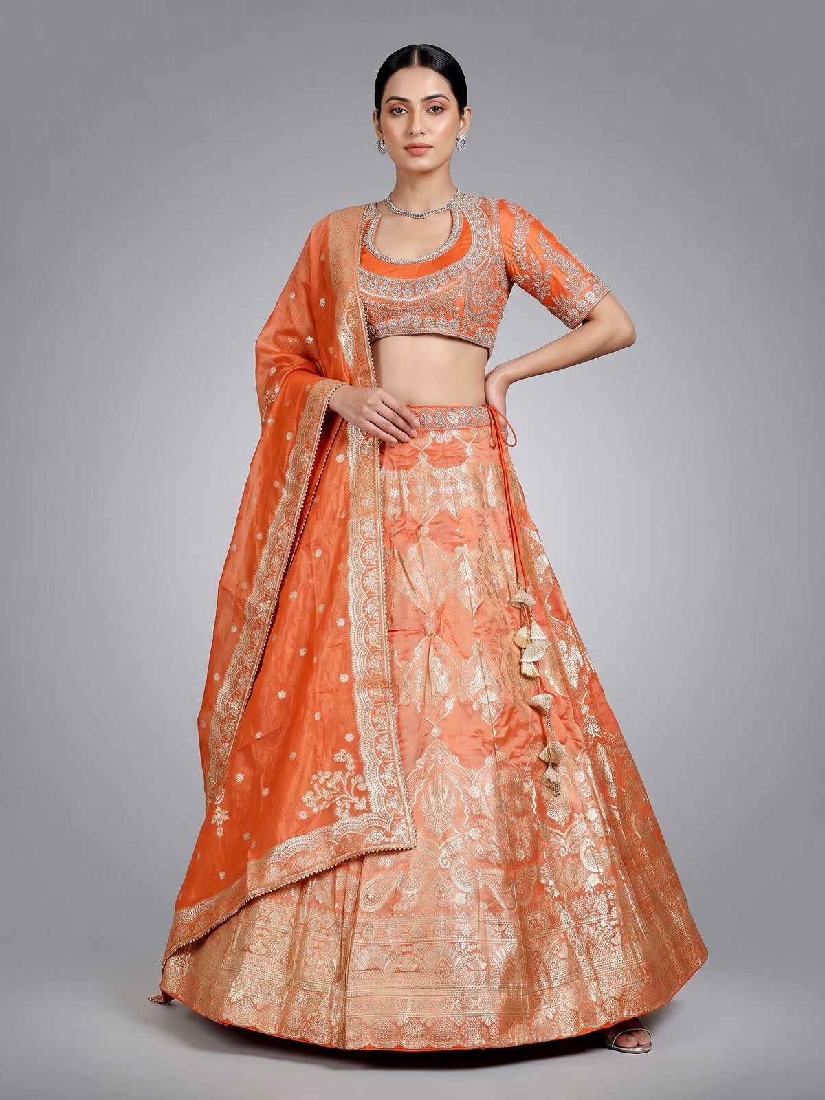 Rust orange banarasi silk lehenga choli with embellished dupatta