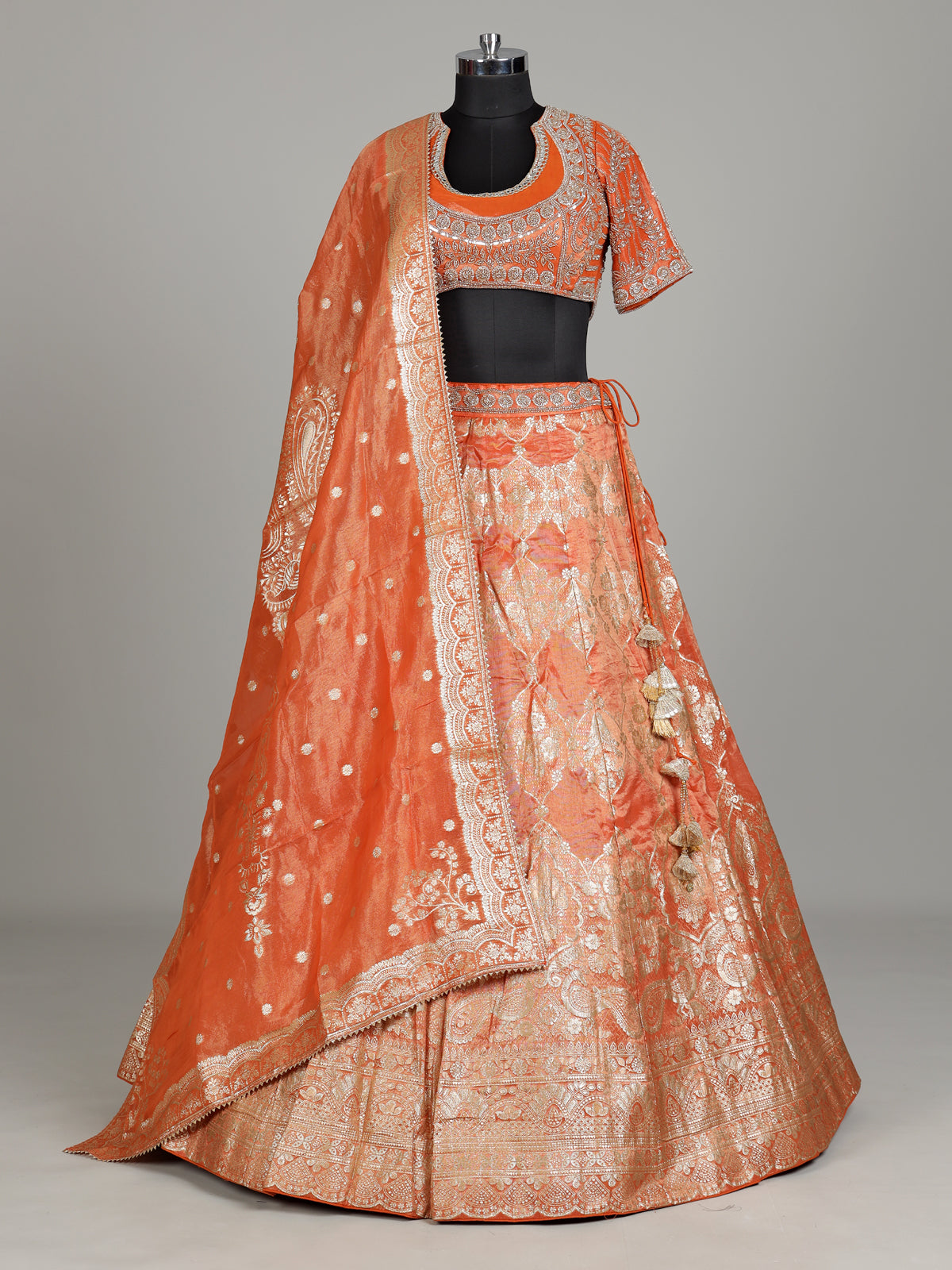 Rust orange banarasi silk lehenga choli with embellished dupatta