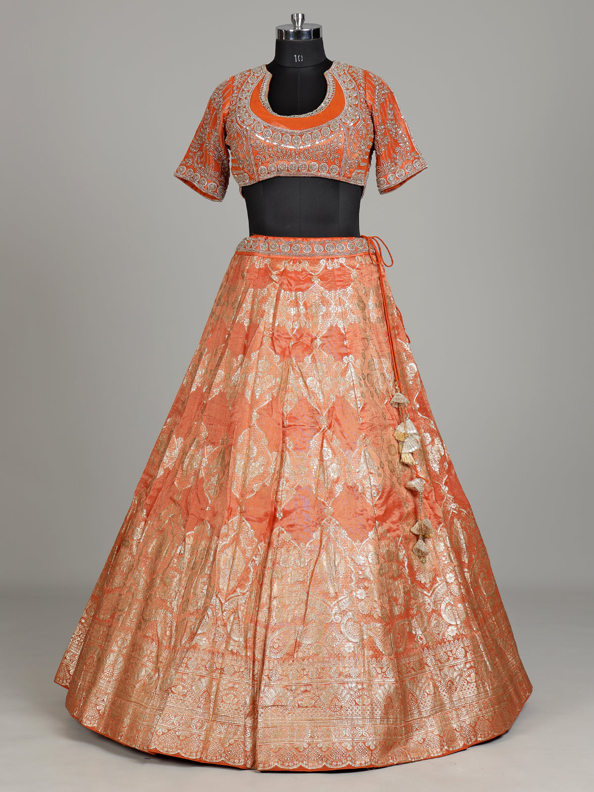 Rust orange banarasi silk lehenga choli with embellished dupatta