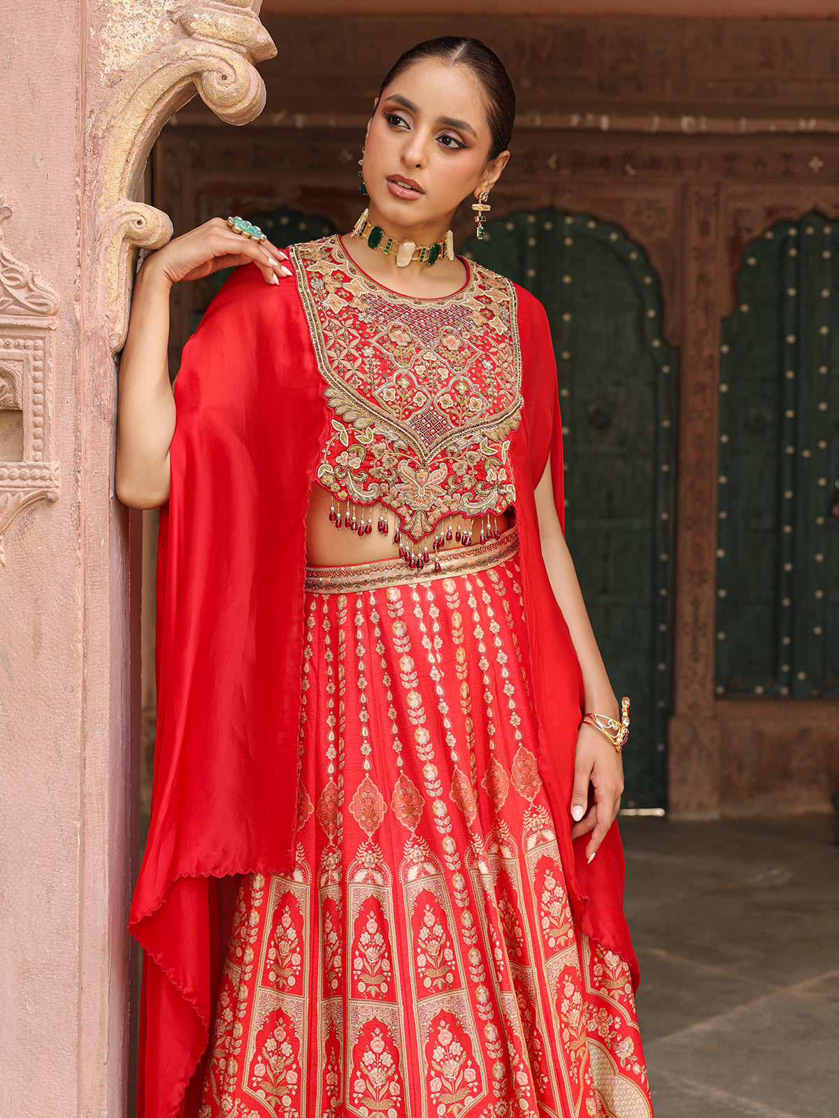 Red traditional printed lehenga choli with heavy work cape jacket