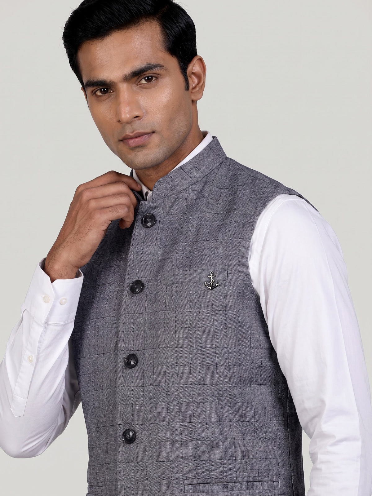 Grey micro-textured waistcoat with metallic brooch for mens weddings