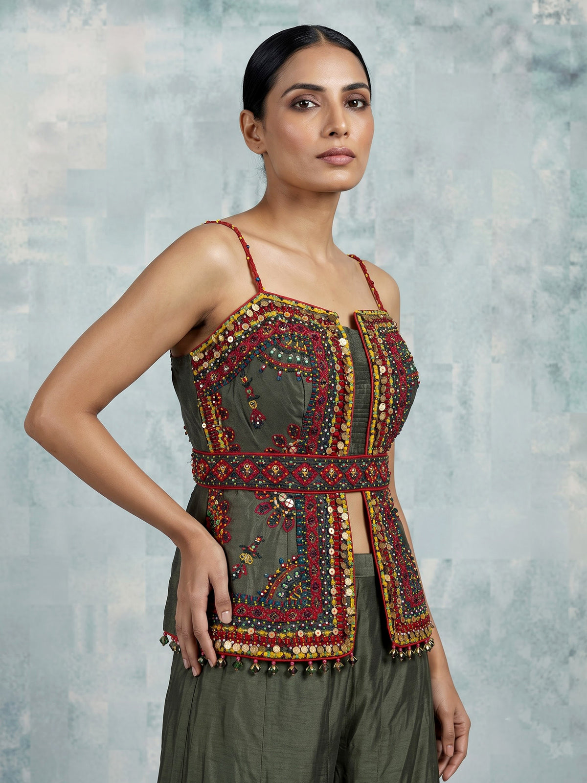 Mehendi green silk designer palazzo suit with festive tassel embellishments