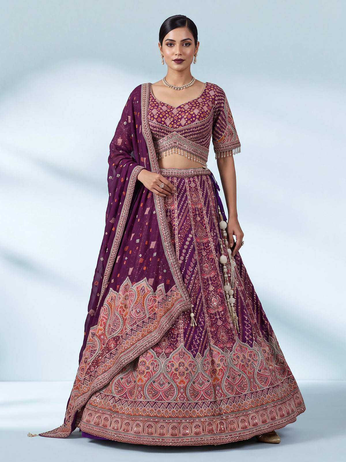 Purple silk lehenga choli with chevron panels and embellished drape