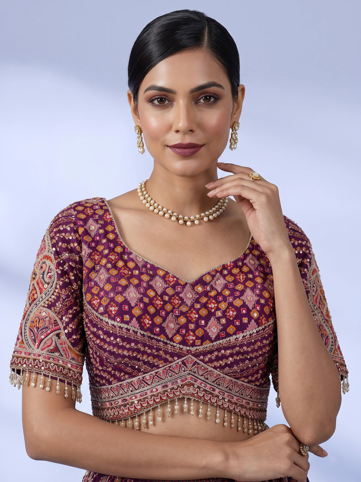 Purple silk lehenga choli with chevron panels and embellished drape