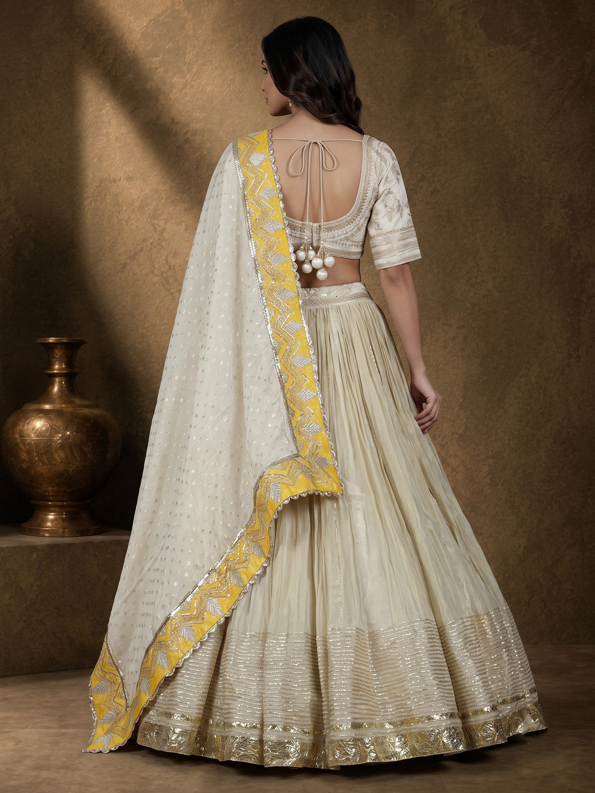 Beige silk lehenga choli with traditional aabla and gota work
