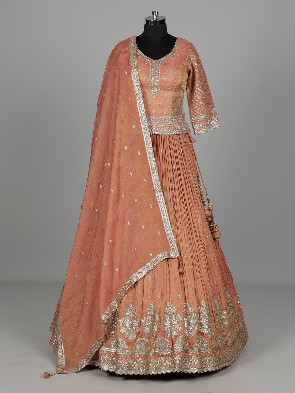 Pastel peach silk lehenga choli with elegant zardosi embroidery