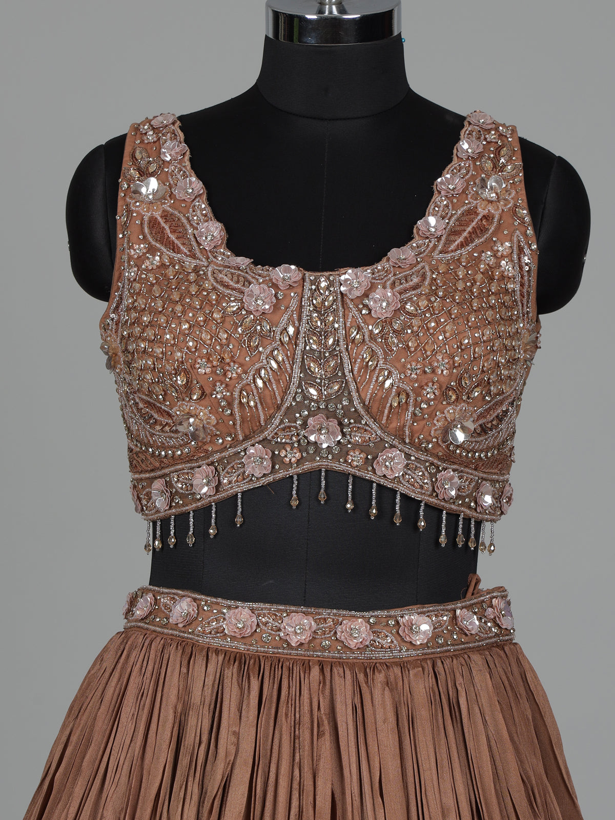Beige chiffon silk lehenga choli with diamond and tassel accents
