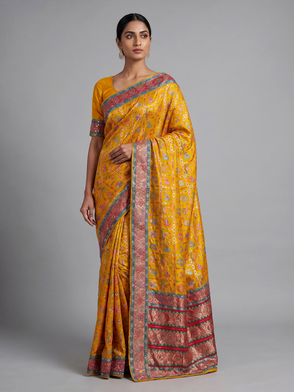 Mustard yellow modal satin saree with colourful motifs and tassel detailing