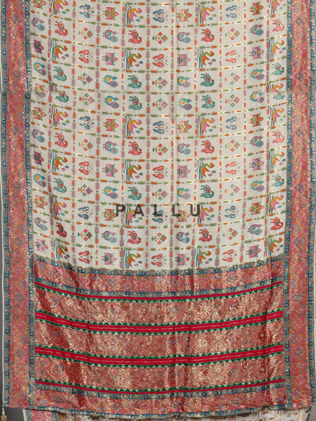 Cream modal satin saree with colourful motifs and intricate zari embellishments