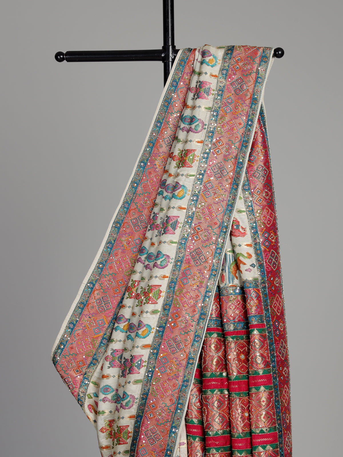 Cream modal satin saree with colourful motifs and intricate zari embellishments