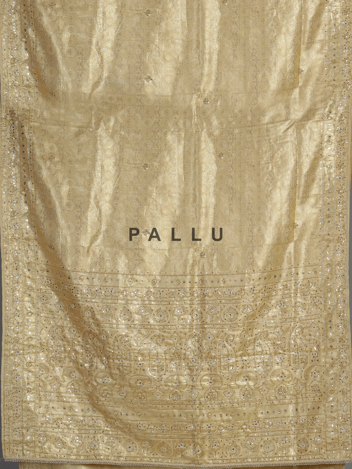 Cream tissue silk saree with mirror accents and intricate festive embroidery