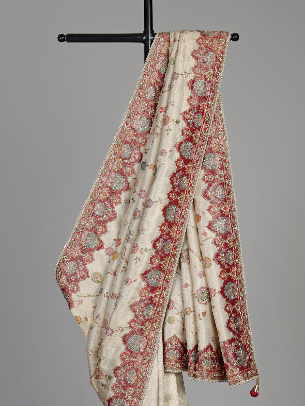 Cream pashmina saree with floral motifs and contrasting embellished border
