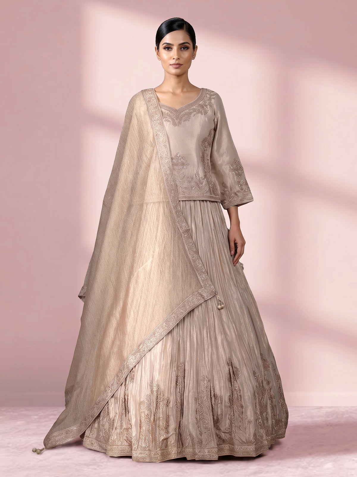 Pastel beige tissue silk lehenga choli with intricate zardosi detailing
