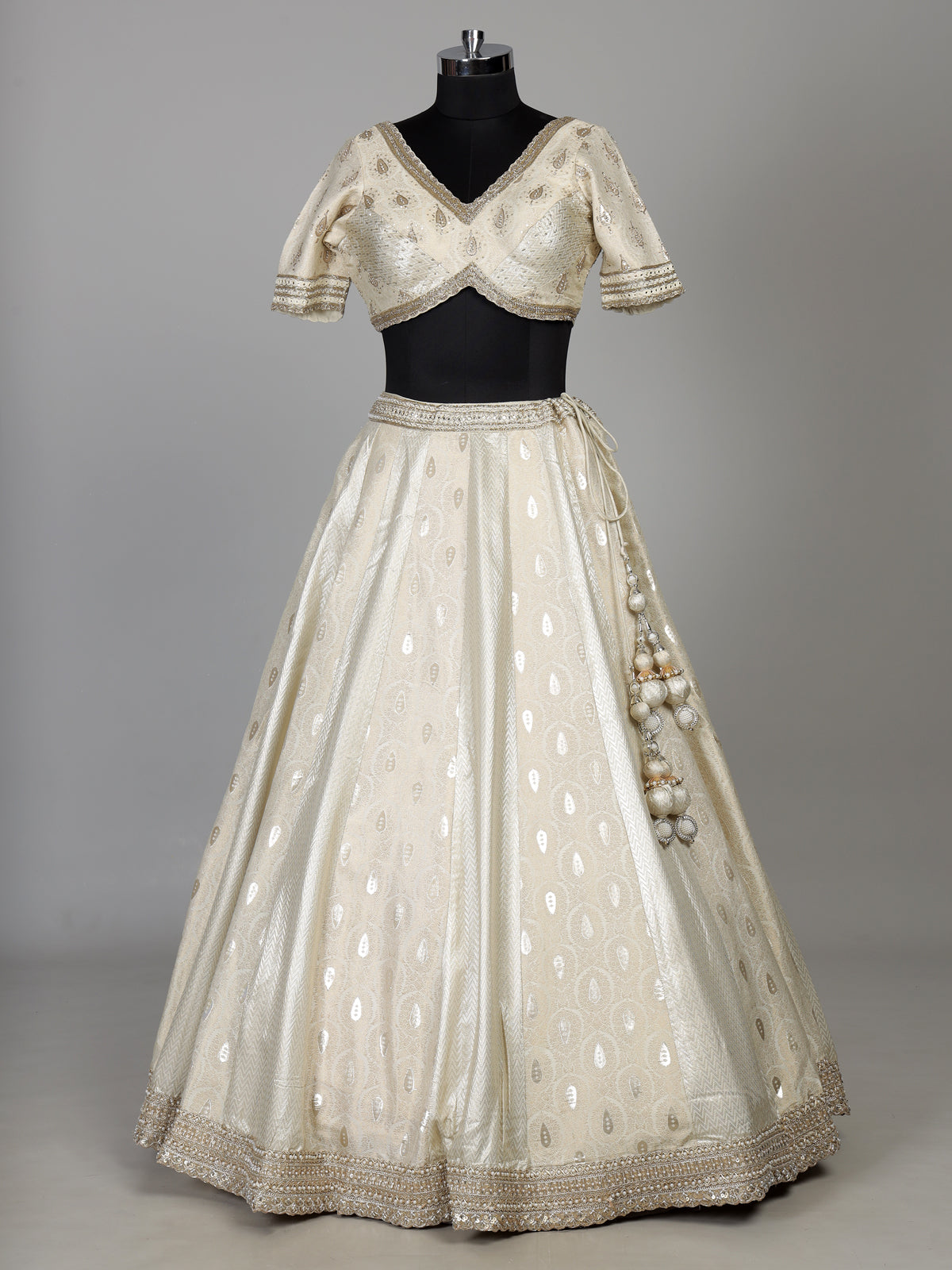 Cream banarasi silk lehenga choli with intricate zardosi embellishments