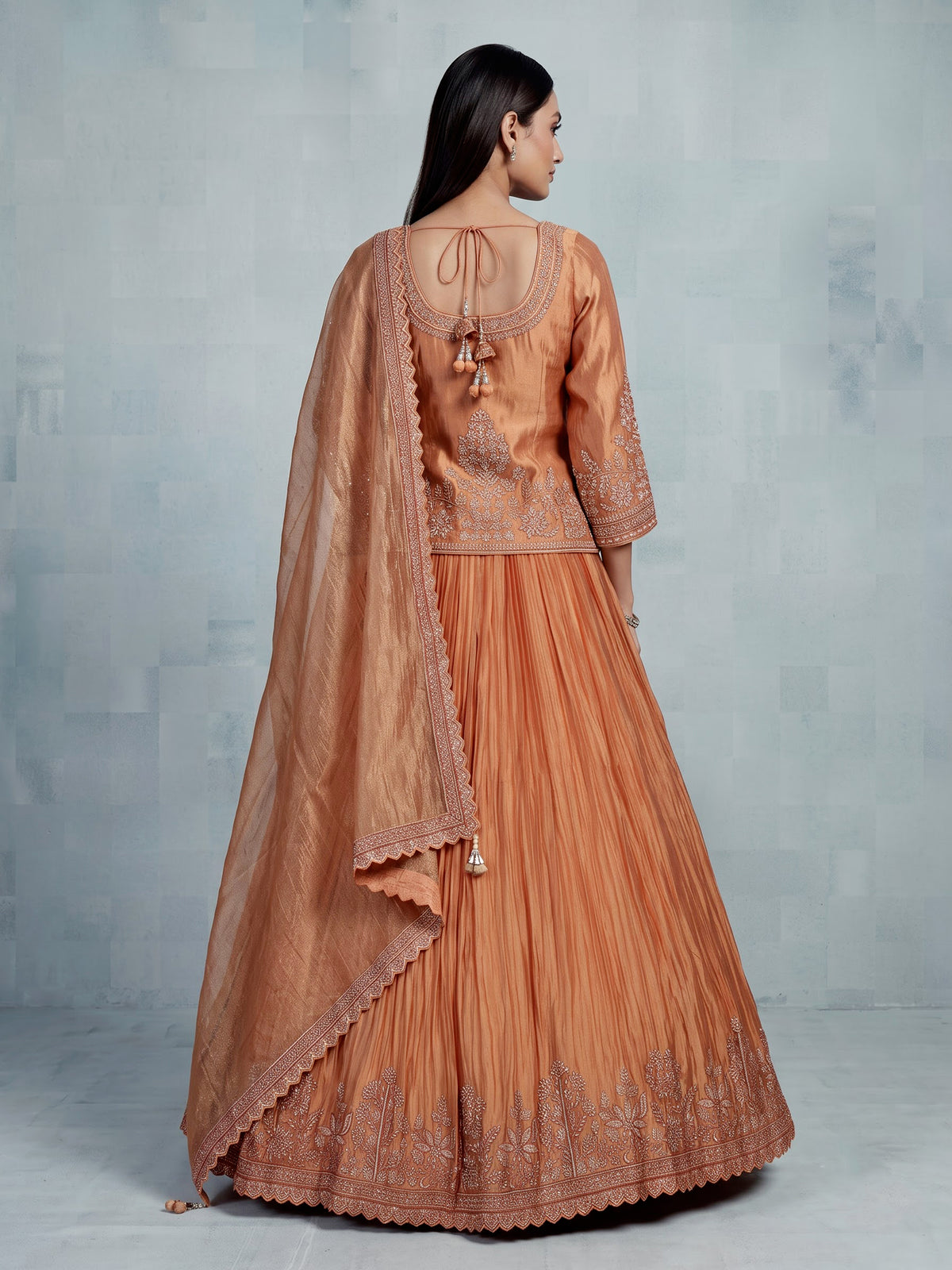 Pastel peach tissue silk lehenga choli with embellished sweetheart neckline