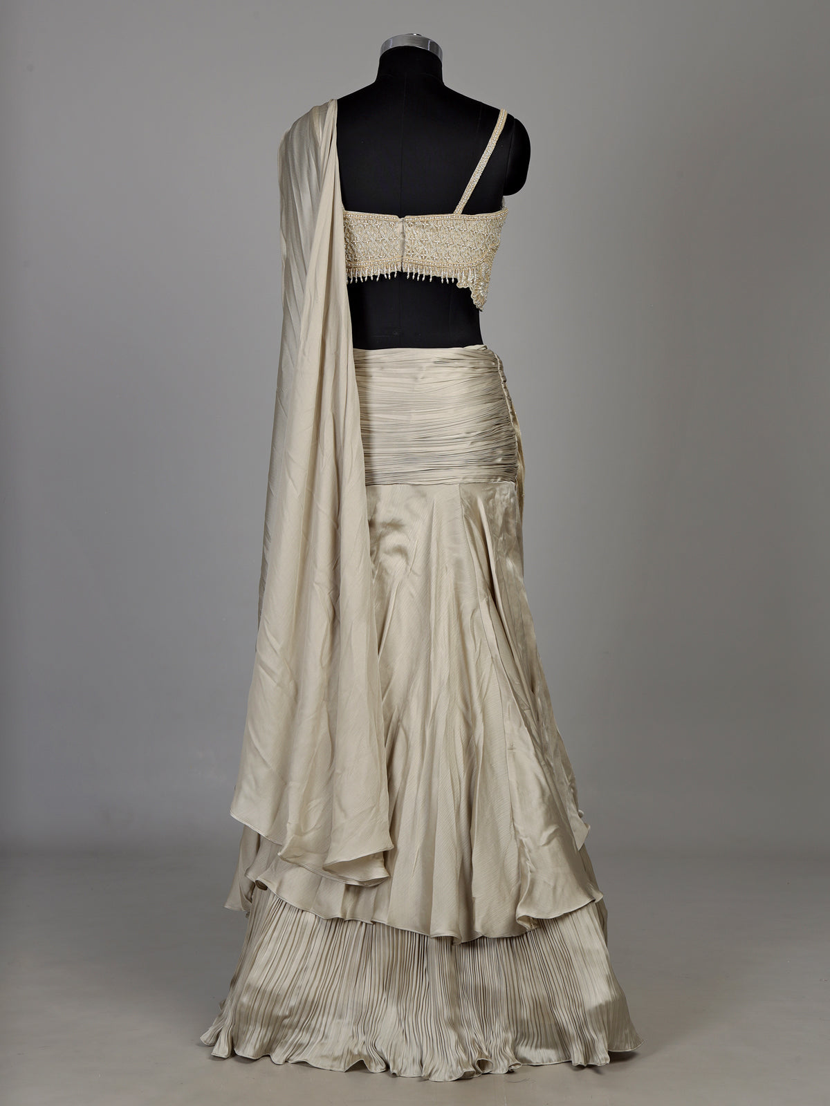 Cream chiffon georgette lehenga choli with pearl and tassel embellishments