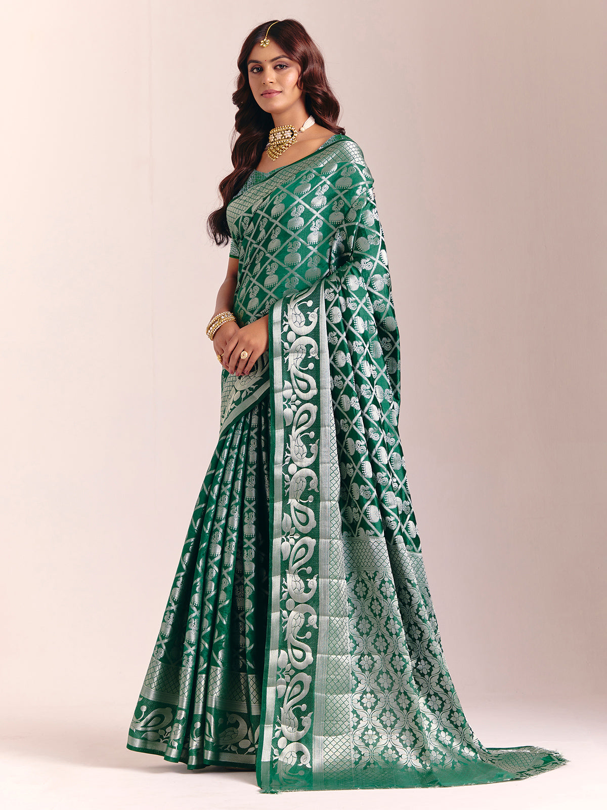 Green silk saree featuring traditional zari detailing