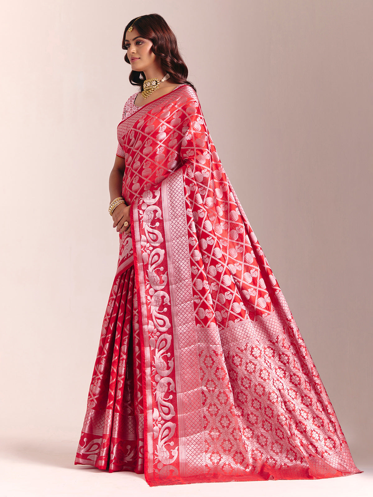 Red silk saree adorned with traditional zari detailing