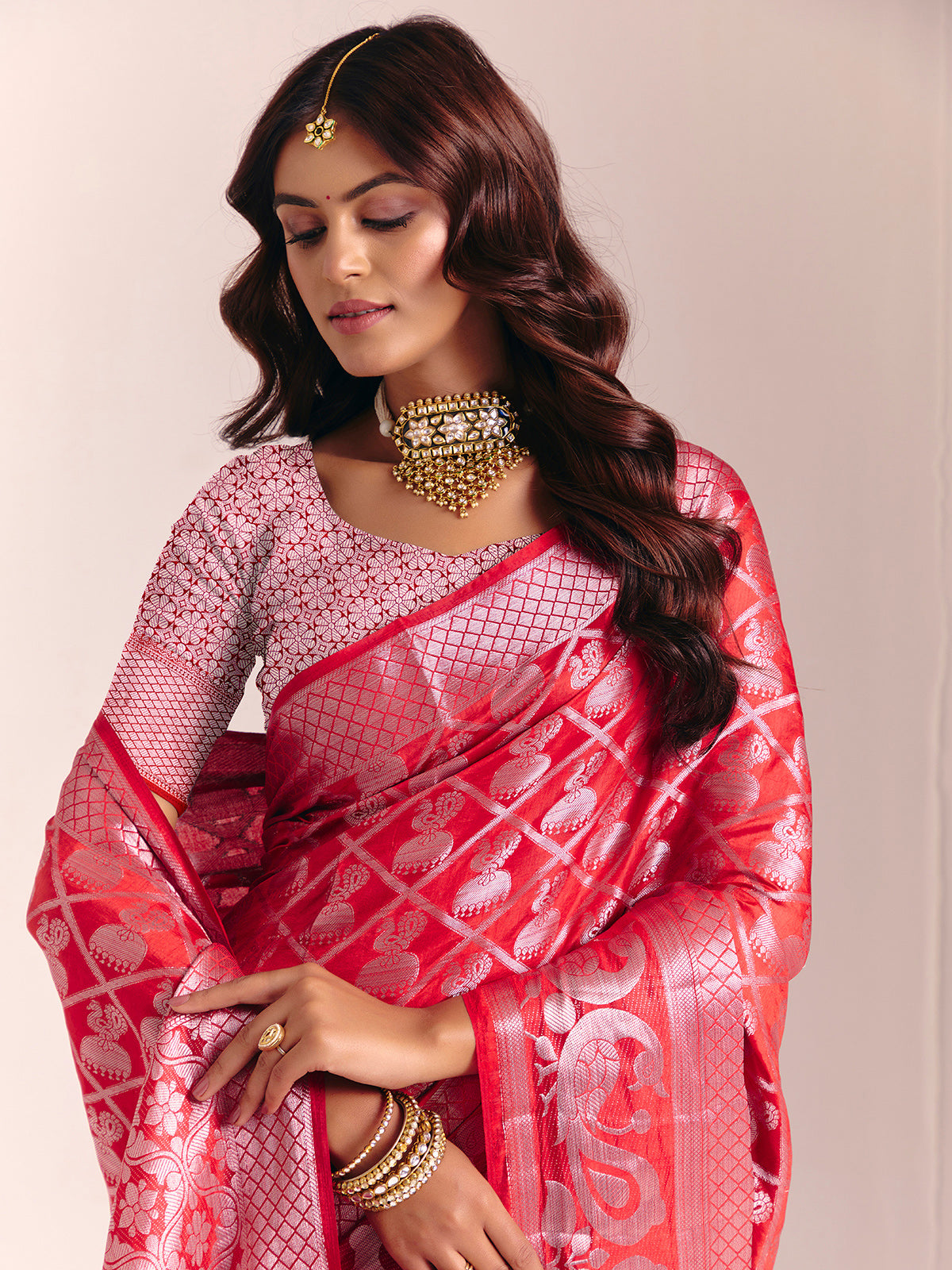 Red silk saree adorned with traditional zari detailing
