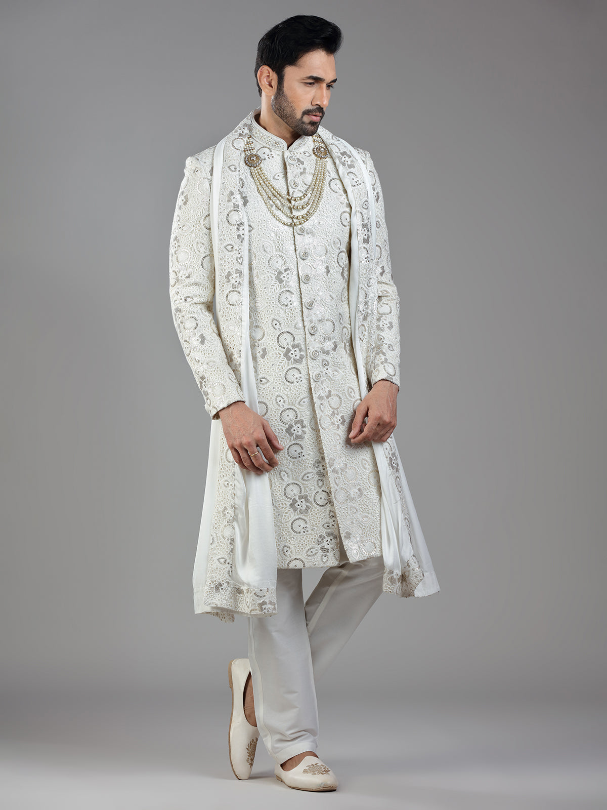 Royal splendor in cream silk with intricate embellishments and rich detailing