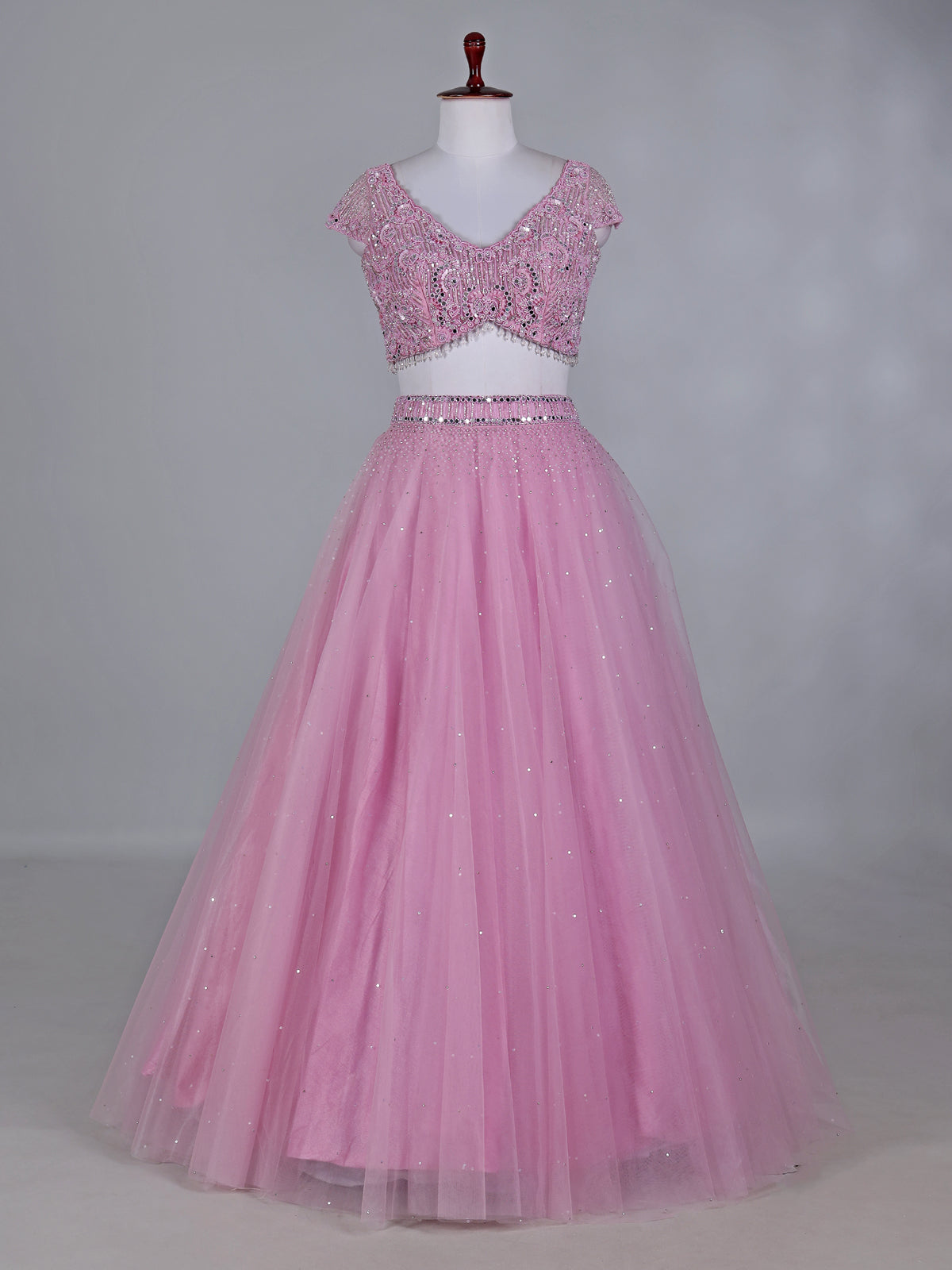 Light pink net lehenga choli with mirror and stone work